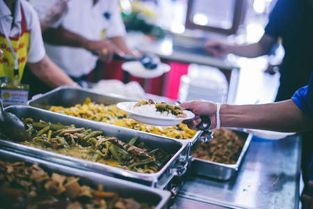 The concept of begging food : Hands of the poor are waiting for food donations to alleviate hungerの写真素材