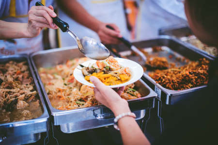 The concept of begging food : Hands of the poor are waiting for food donations to alleviate hungerの写真素材