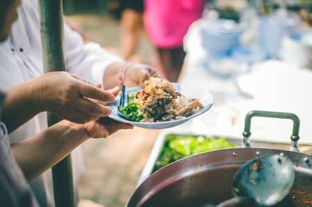 The concept of starvation : The hands of beggars receive donated foodの写真素材