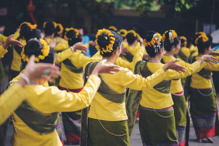 The lady dancing in traditional yellow clothesの写真素材