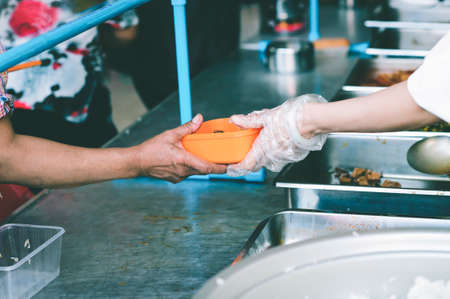 Volunteers Share Food to the Poor to Relieve Hunger: Concept poverty and donationの写真素材
