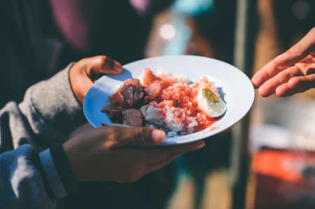 Hand-feeding to the needy in society : Concept of Feedingの写真素材