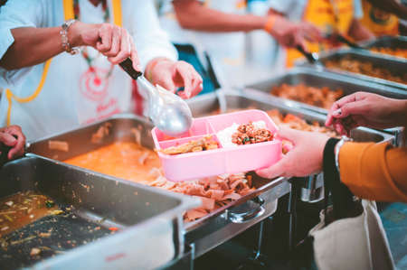The concept of sharing: Participation in sharing food for the poorの写真素材