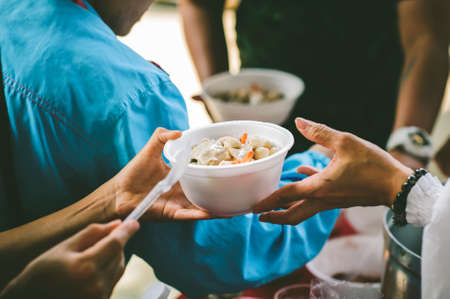 Free food for poor and homeless people: concept of sharingの写真素材