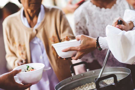 The concept of sharing: Participation in sharing food for the poorの写真素材