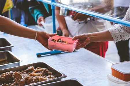 Donate food to the poor and hungry: Concept of Feedingの写真素材