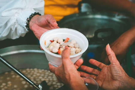 The Hand of the Beggars receives charity food from fellow human beings: Concepts of feedingの写真素材