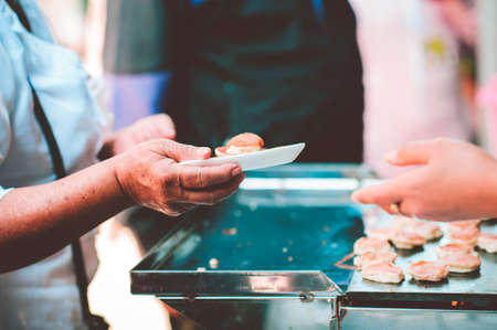 Sharing of food from volunteer hands to homeless people : The concept of sharingの写真素材