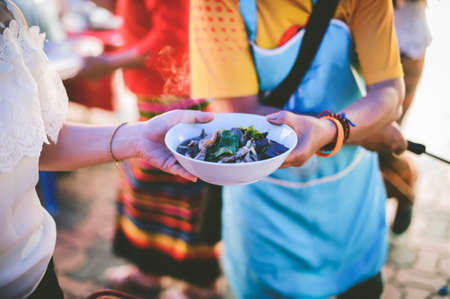 Volunteers Share Food to the Poor to Relieve Hunger: Charity food conceptの写真素材