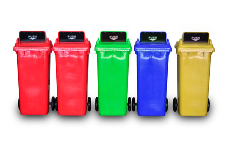 Red, green, blue, yellow plastic trash can with lids isolated on white backgroundの写真素材
