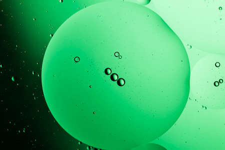 Abstract water droplets on the glass with a colored blurred backgroundの写真素材