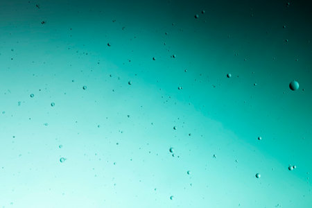 Abstract water droplets on the glass with a colored blurred backgroundの写真素材