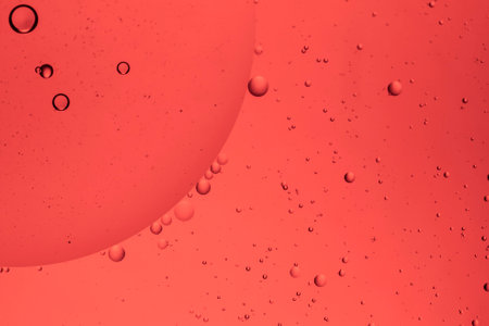 The beauty of abstract oil floating on the water surface with colored background.