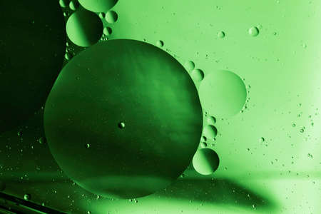 Abstract image of water droplets on glass surface reflecting with multicolored background.の写真素材
