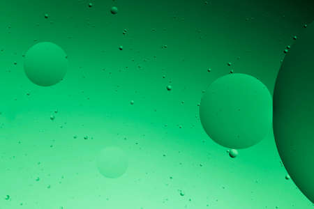 The beauty of abstract oil floating on the water surface with colored background.の写真素材