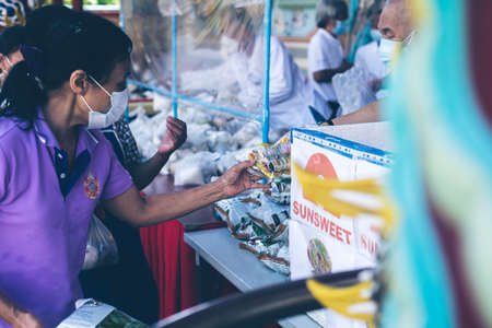 CHIANG MAI, THAILAND - October 6, 2021: People and villagers come to pick up vegetarian food from volunteers who donate in Chiang Mai, Thailand.のeditorial素材