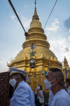 LAMPHUN, THAILAND - MAY 15, 2022: Auspicious water jars are hung on ropes, pulled up and down to bring water to Phra That Chedi at the annual Phra That Haripunchai Bathing Ceremony in Lamphun Province.のeditorial素材