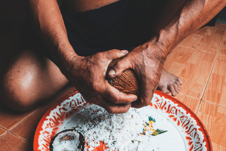 Coconut scraping by hand in rural Thailand style.の写真素材