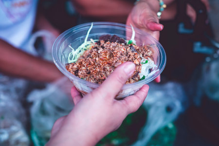 Hands of hungry beggar requesting free food from volunteers : concept of giving and sharingの写真素材