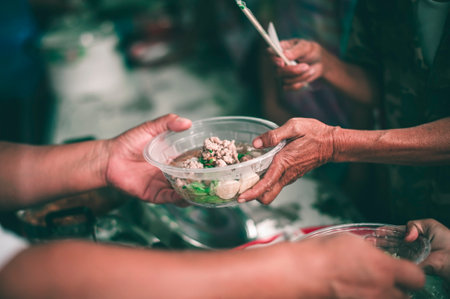 Sharing food for the hungry homeless: the concept of a sharing society.の写真素材