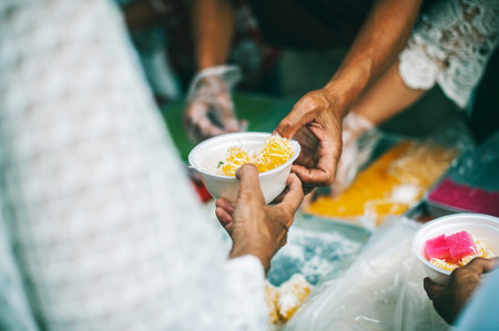 The concept of humanitarian assistance: sharing food to the poor.の写真素材
