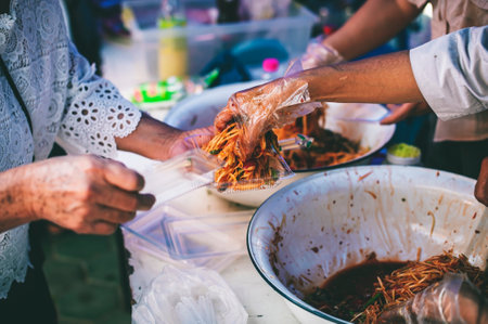 Volunteers are donating free charity food to the poor in the community : Help and food bank conceptの写真素材