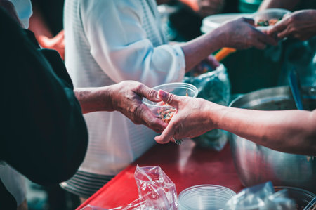 Volunteer to serve free food for the poor in a food donation center : charity conceptの写真素材