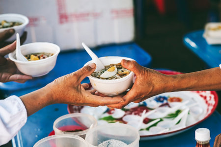 Volunteer to serve free food for the poor in a food donation center : charity conceptの写真素材