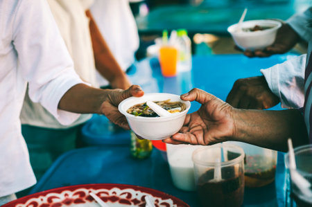 Volunteers give food to the poor, share free food to help beggars. food donation concept