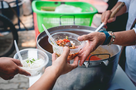 Helping and donating food to the poor: the idea of giving and eating for free.の写真素材