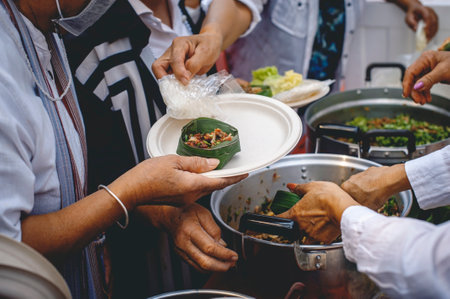 Volunteers share food aid with the poor in the community.の写真素材