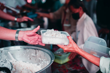 Charity concept : donate food to the beggar.の写真素材