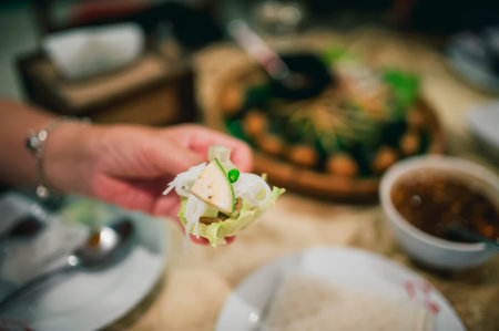 Nam Nueng, a Vietnamese dish, is a dish consisting of vegetable dough, salad, raw bananas, chili, garlic, and pork, then topped with a sweet dipping sauce.の写真素材