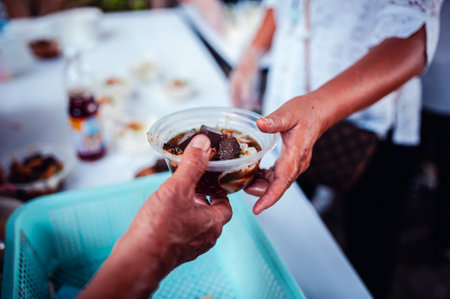 concept of charity food for the poor : the concept of life problems, hunger in society : Helping People With Hunger With Kindness : The hands of beggars receive donated foodの写真素材
