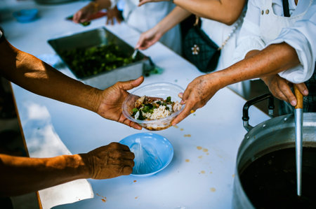 concept of charity food for the poor : the concept of life problems, hunger in society : Helping People With Hunger With Kindness : The hands of beggars receive donated foodの写真素材