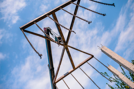 The arm of the machine lifts floor slabs in building construction.