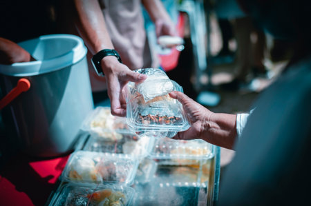 Feeding the poor to hands of a beggar Poverty concept Charity concept, hands of the poor receive...