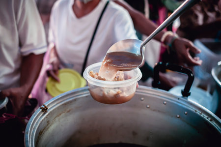 The hand of a beggar received food from a compassionate person, Concept of sharingの写真素材