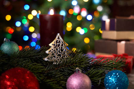 Christmas decoration on table with Christmas tree in the background.の写真素材