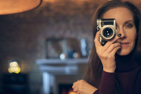 Woman holding retro styled cameraの写真素材