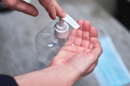 Man washing hand with alcohol-based liquid, applying and sanitizer gel, using disinfectant.の写真素材