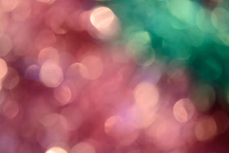 Bokeh photo. Holiday background. Christmas lights. Defocused sparkles. New Year backdrop. Festive wallpaper. Blinks. Carnival. Bokeh retro style photo. Pink.の写真素材