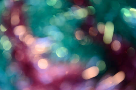 Bokeh photo. Holiday background. Christmas lights. Defocused sparkles. New Year backdrop. Festive wallpaper. Blinks. Carnival. Bokeh retro style photo. Pink.の写真素材