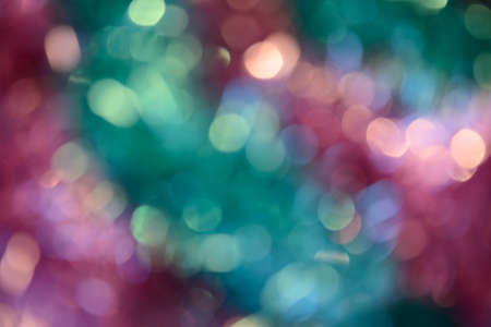 Bokeh photo. Holiday background. Christmas lights. Defocused sparkles. New Year backdrop. Festive wallpaper. Blinks. Carnival. Bokeh retro style photo. Pink.の写真素材