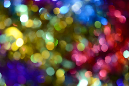 Bokeh. Holiday background. Christmas lights. Glitter. Defocused sparkles. New Year backdrop. Festive wallpaper. Blinks. Carnival. Tinsel. Bokeh retro style photo.の写真素材