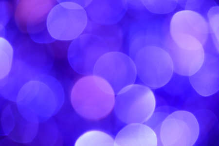 Bokeh. Holiday background. Christmas lights. Glitter. Defocused sparkles. New Year backdrop. Festive wallpaper. Blinks. Carnival. Tinsel. Bokeh retro style photo.の写真素材
