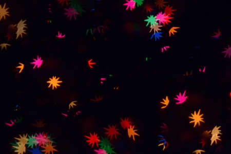 Bokeh lights background. Stars bokeh defocused background. Holiday background. Garland. Defocused blinks. New Year. Bokeh retro style photo.の写真素材