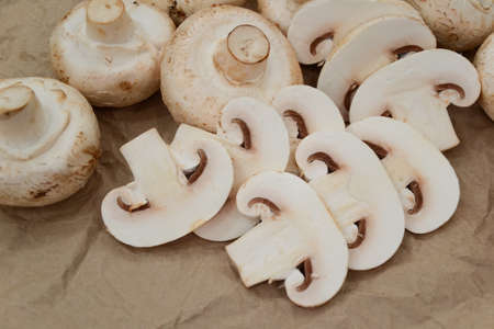 Mushrooms. Champignons on old paper background. Country style. Forest harvest. Cultivated mushrooms....