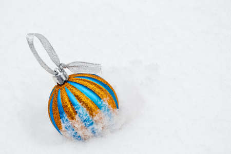 Christmas tree ball on freshly fallen snow. Cold frosty weather. White. Winter background. New Year wallpaper.の写真素材