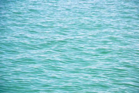 Sea water. Turquoise clear water. Summer background. Ocean dark blue water in sunny day. Tropical...